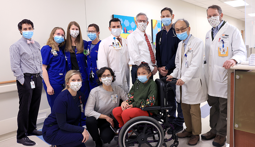The MDA team posing with a patient in the neuromuscular clinic.